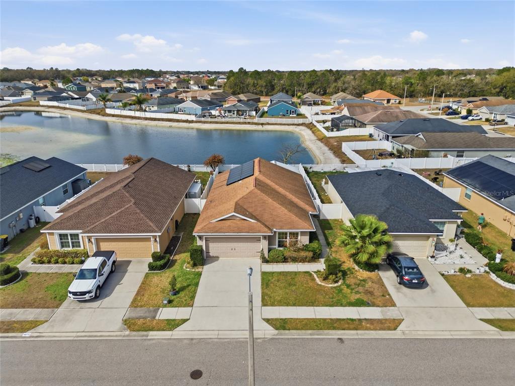 4066 Sundance Pl Loop Mulberry, FL 33860 - Photo 26 of 28 an aerial view of a house with a garden and lake view
