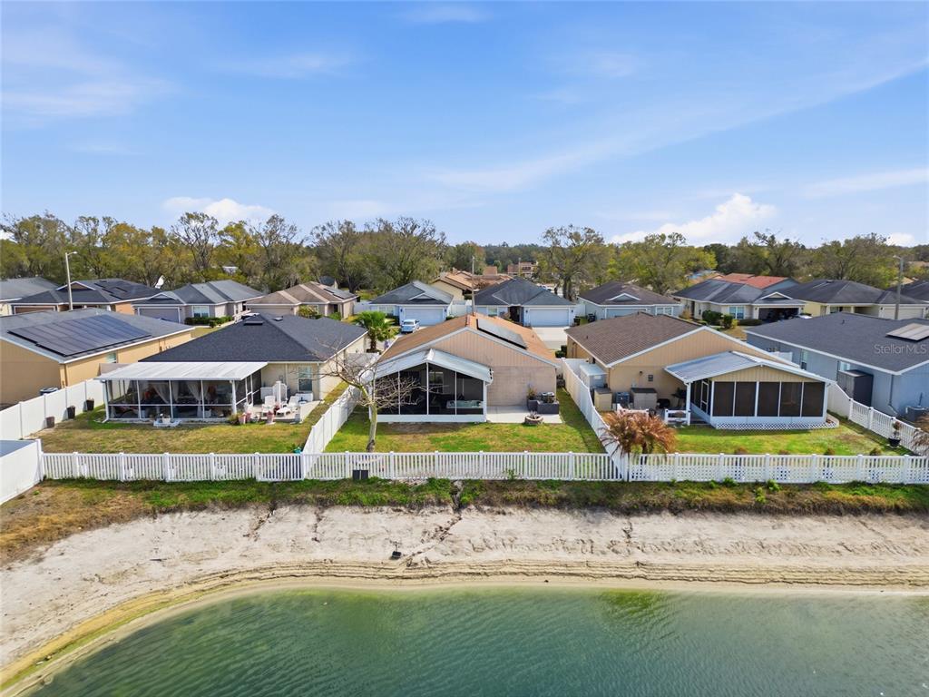 4066 Sundance Pl Loop Mulberry, FL 33860 - Photo 28 of 28 a view of a large white building with a swimming pool and lawn chairs