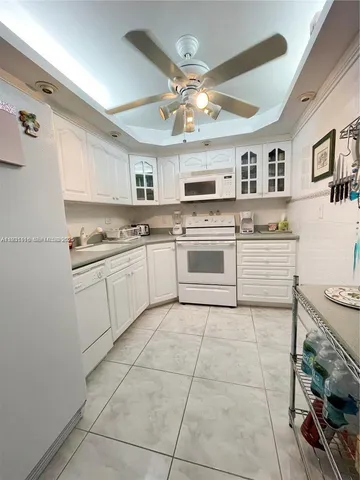 a kitchen with a stove sink and cabinets