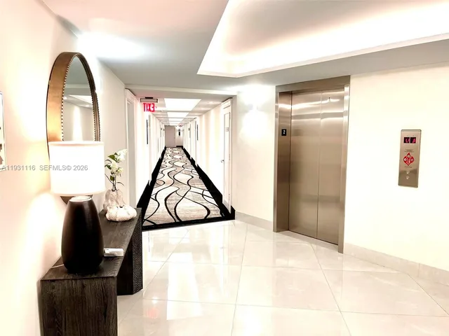 a kitchen with stainless steel appliances granite countertop white cabinets and window