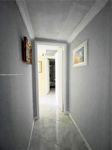 a view of a hallway with wooden shelves