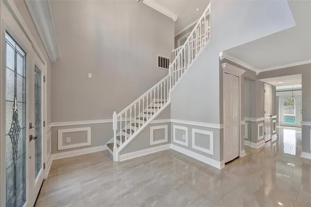 a large kitchen with stainless steel appliances granite countertop a refrigerator a sink a stove and oven