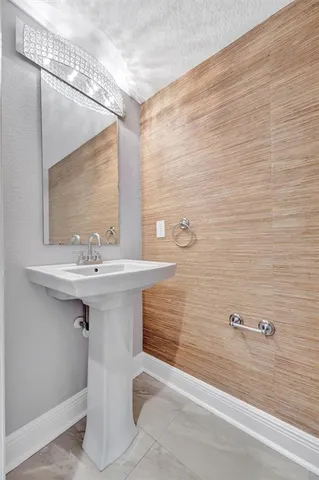 a view of empty room with wooden floor and kitchen
