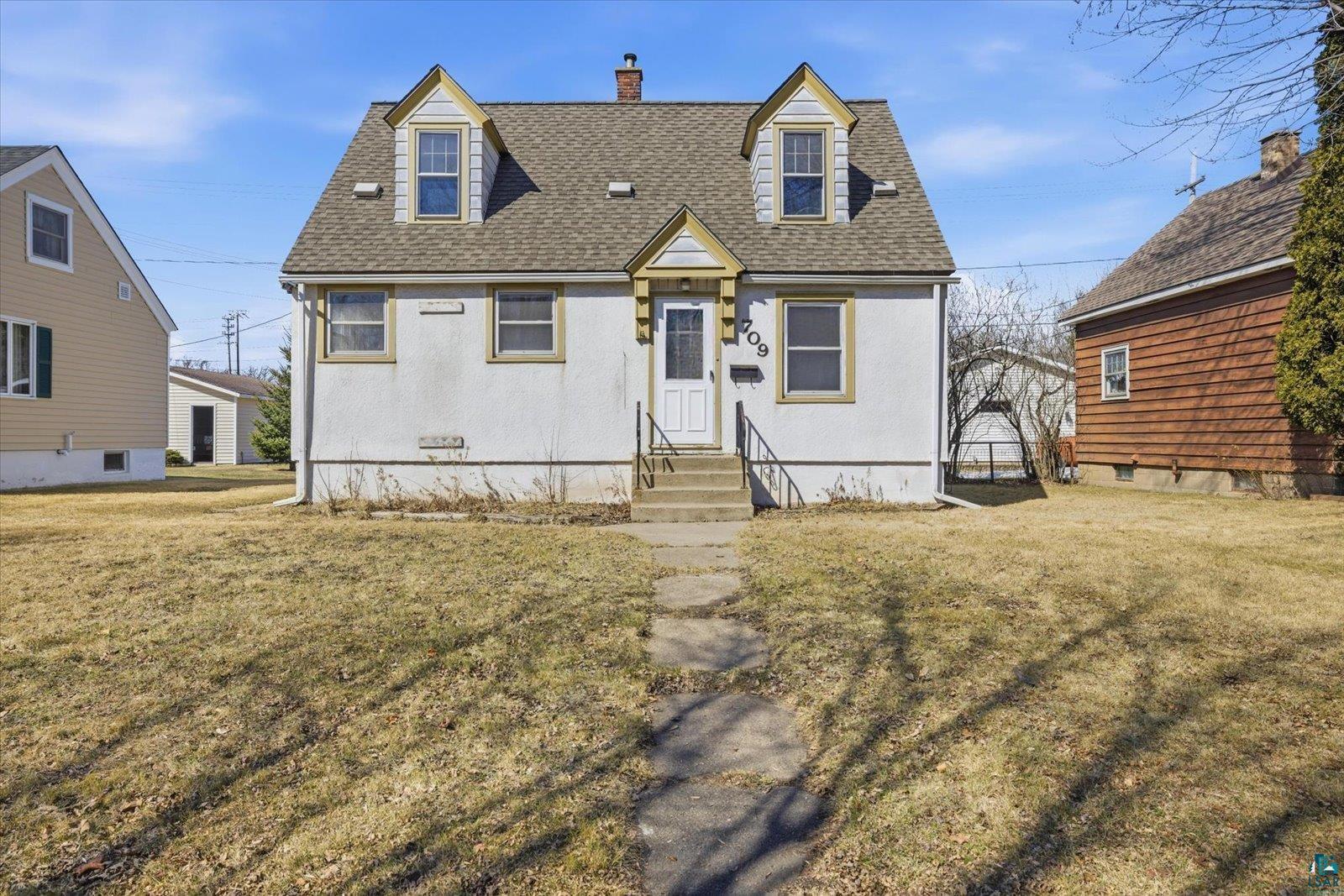 709 Michigan Street Hibbing, MN 55746 - Photo 1 of 47 Cape cod home with roof with shingles, a front yard, and a chimney