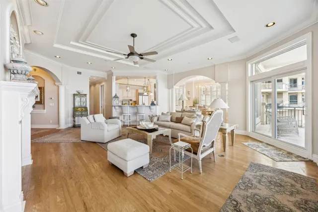 a living room with fireplace furniture and a large window