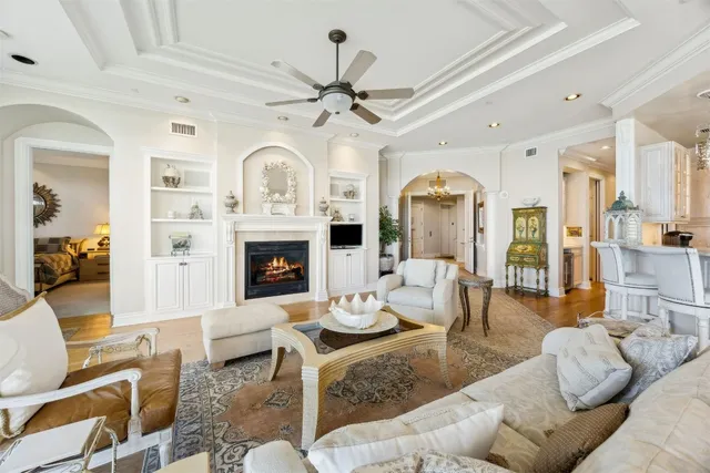 a living room with furniture a fireplace and a chandelier