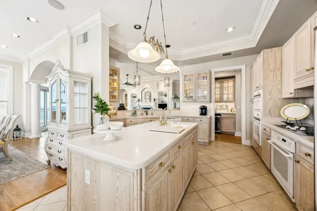 a large kitchen with kitchen island a stove a sink a center island and furniture
