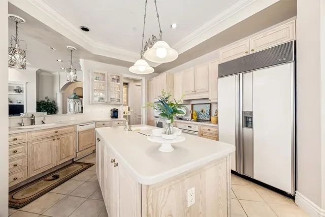 a kitchen with kitchen island granite countertop a sink and refrigerator