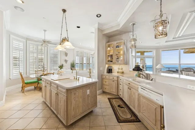 a large white kitchen with a large window