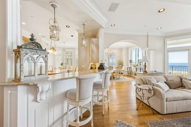 a very nice looking living room with a large window and chandelier