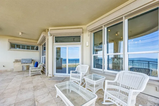a view of a balcony with chair and table