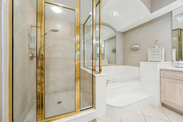 a large white kitchen with stainless steel appliances granite countertop a sink and cabinets