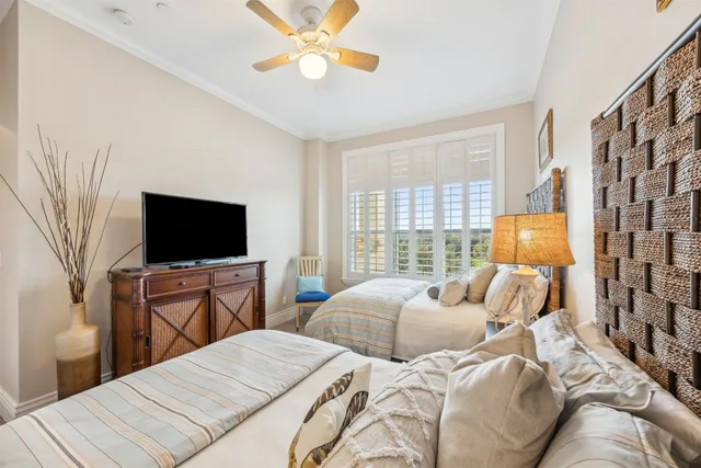 a bedroom with two beds and a lamp