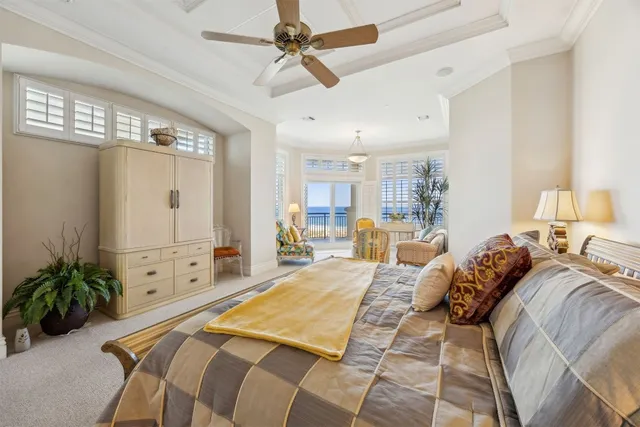 a bedroom with a bed a large mirror and potted plant