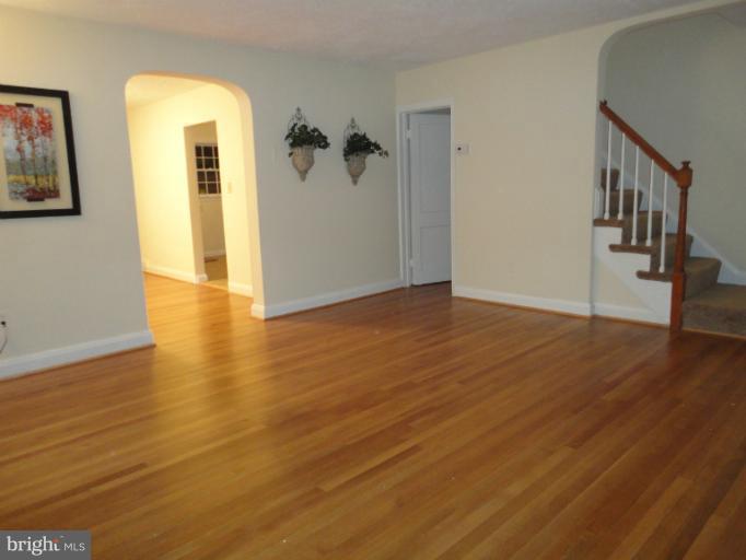 4930 Lindsay Road Baltimore, MD 21229 - Photo 2 of 25 a view of a hallway view with wooden floor and staircase