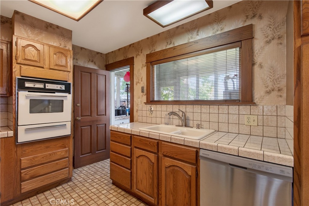 4045 Elmwood Court Riverside, CA 92506 - Photo 7 of 18 Updated kitchen with doorway into the enclosed laundry porch.