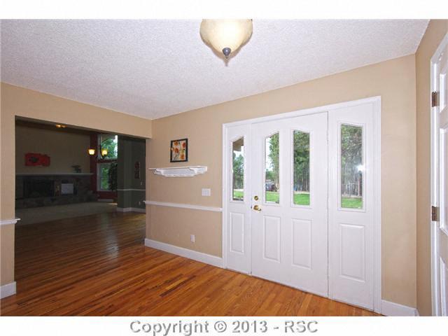 4425 Shoup Road Colorado Springs, CO 80908 - Photo 4 of 25 Large open foyer w/beautiful hardwood flooring and open to the great room
