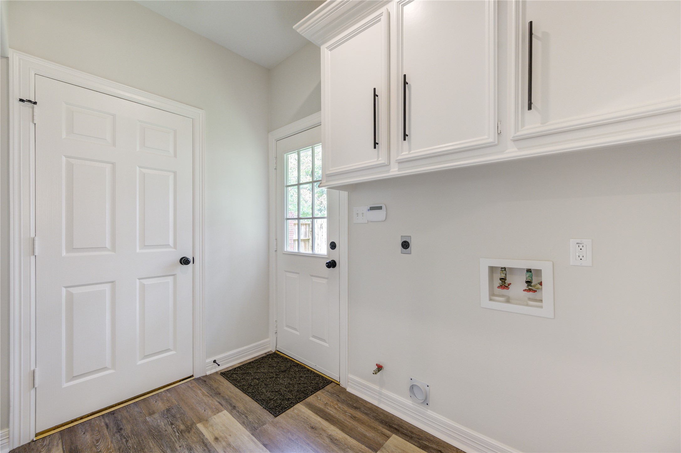 17318 Bonnard Circle Spring, TX 77379 - Photo 41 of 45 The laundry room features electric and gas service, and has a space for a secondary fridge. There is also an exterior door that leads out to the large side yard!