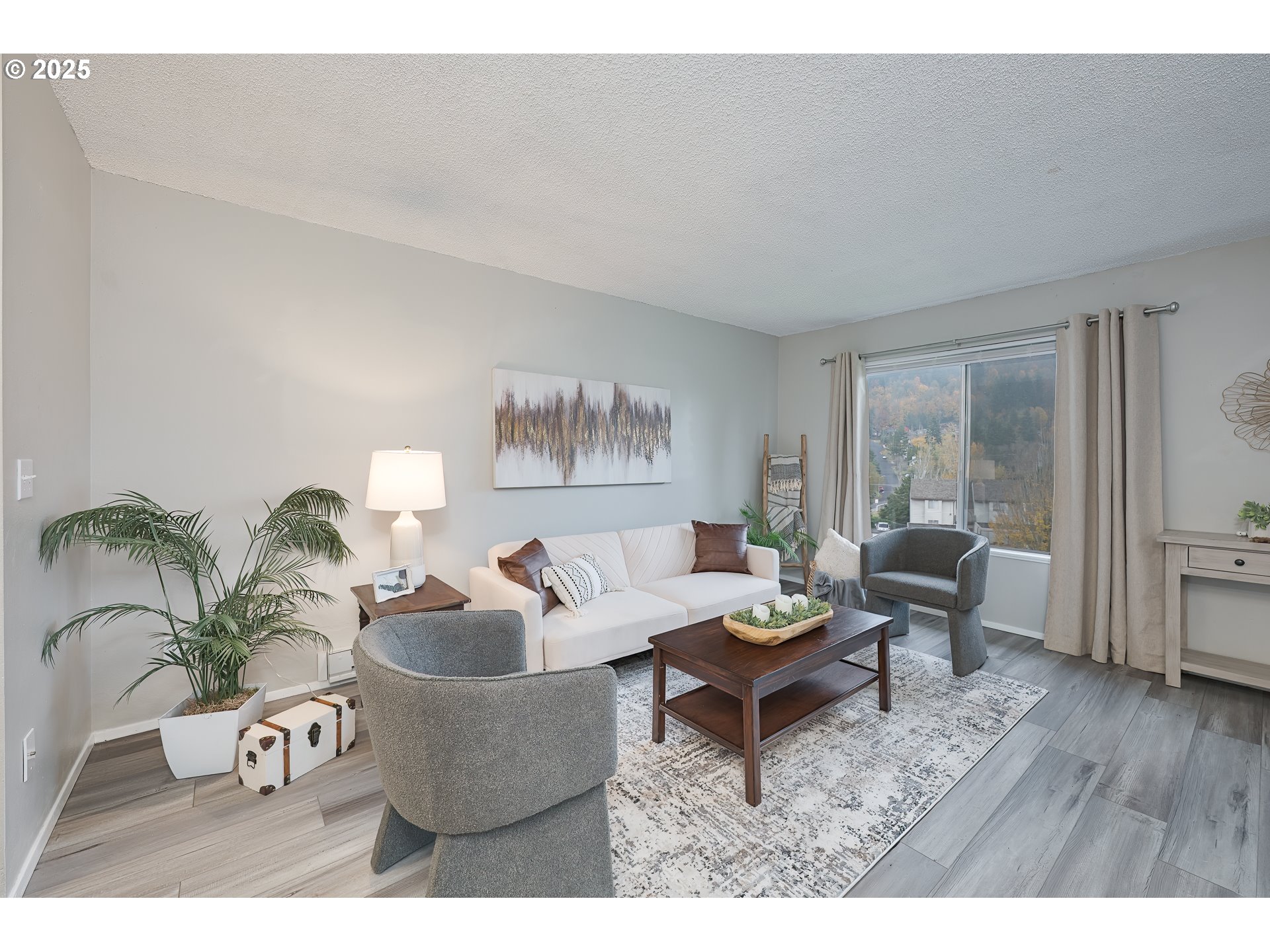 200 Southwest Florence Avenue, Unit D12 Gresham, OR 97080 - Photo 3 of 24 a living room with furniture and wooden floor