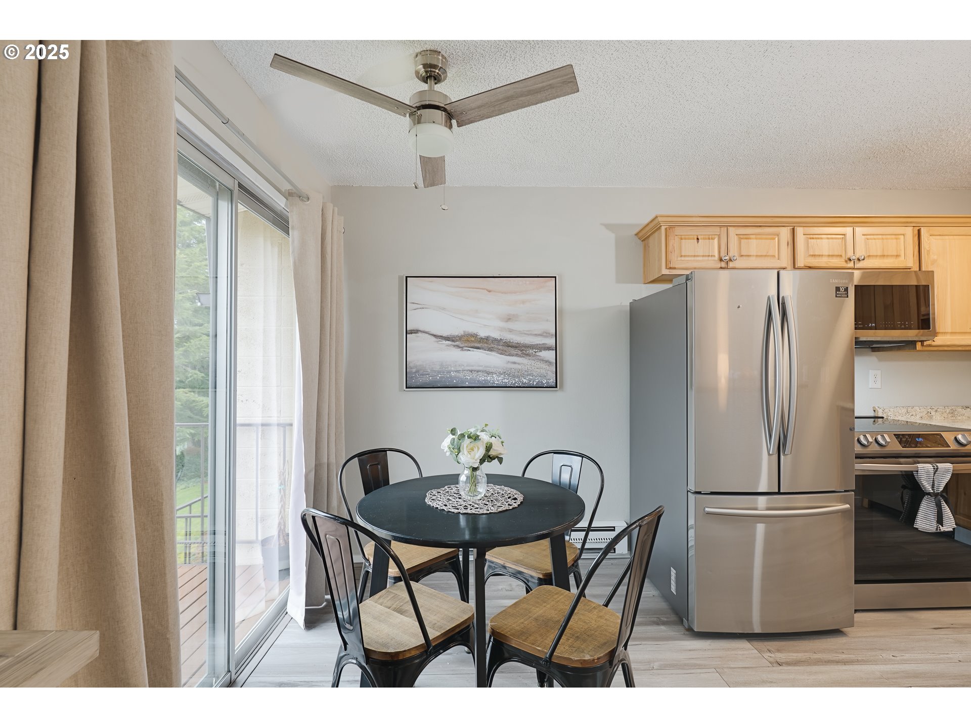 200 Southwest Florence Avenue, Unit D12 Gresham, OR 97080 - Photo 7 of 24 a kitchen with stainless steel appliances a refrigerator and a table