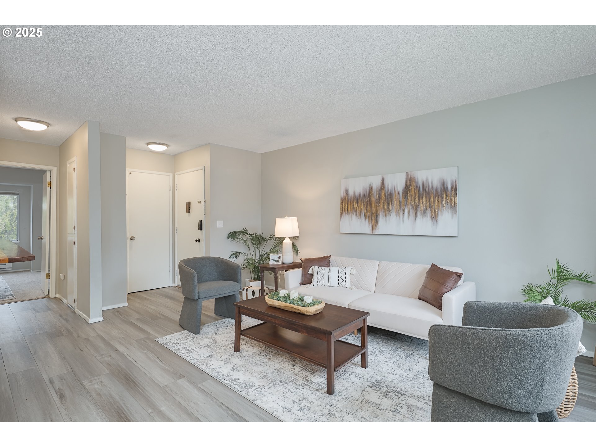 200 Southwest Florence Avenue, Unit D12 Gresham, OR 97080 - Photo 8 of 24 a living room with furniture and a wooden floor
