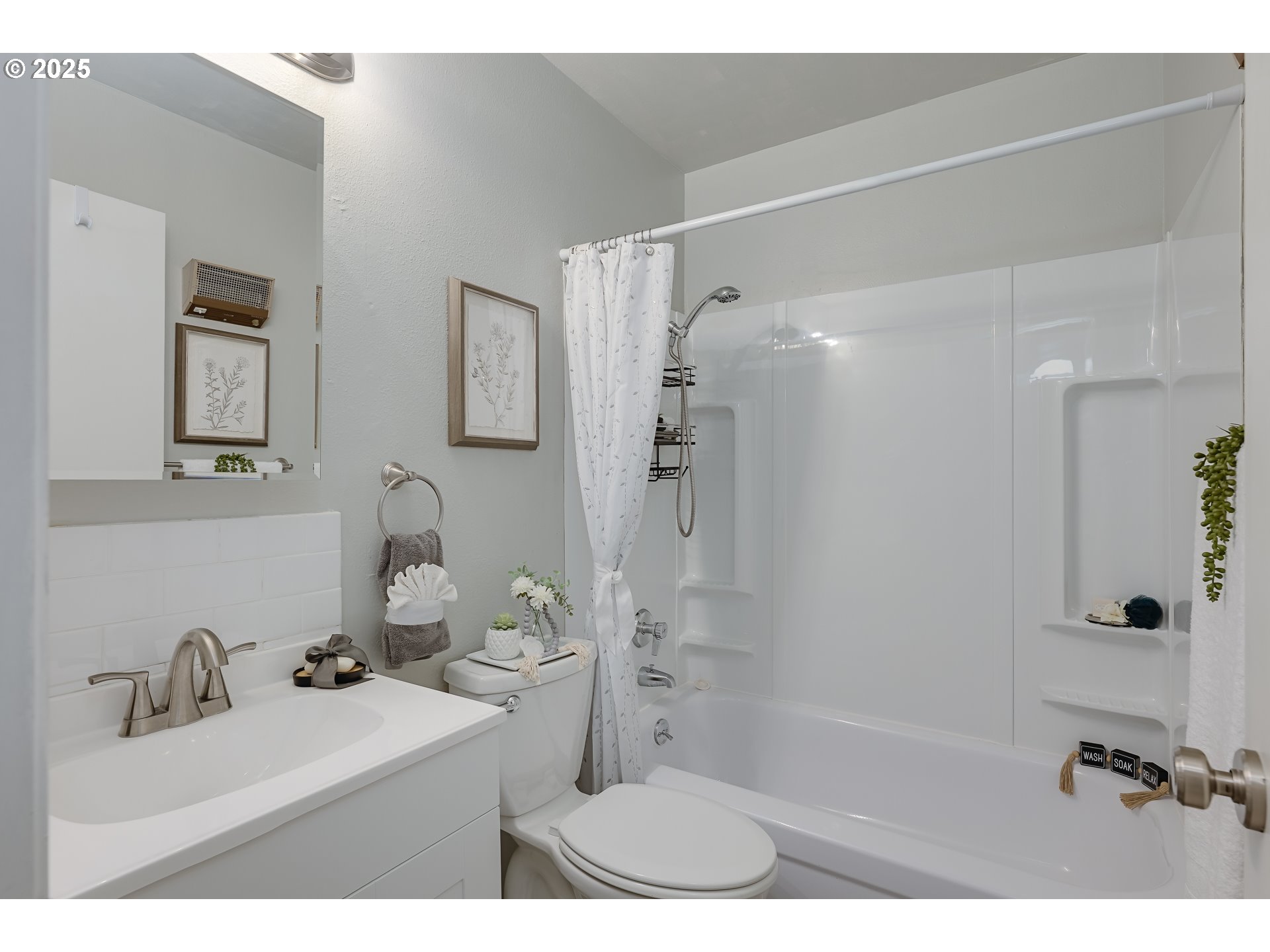 200 Southwest Florence Avenue, Unit D12 Gresham, OR 97080 - Photo 9 of 24 a bathroom with a sink mirror toilet shower and bathtub