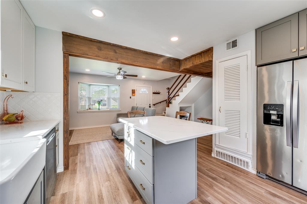 2924 West 11th Street Irving, TX 75060 - Photo 36 of 39 a kitchen with a sink a refrigerator and wooden floor