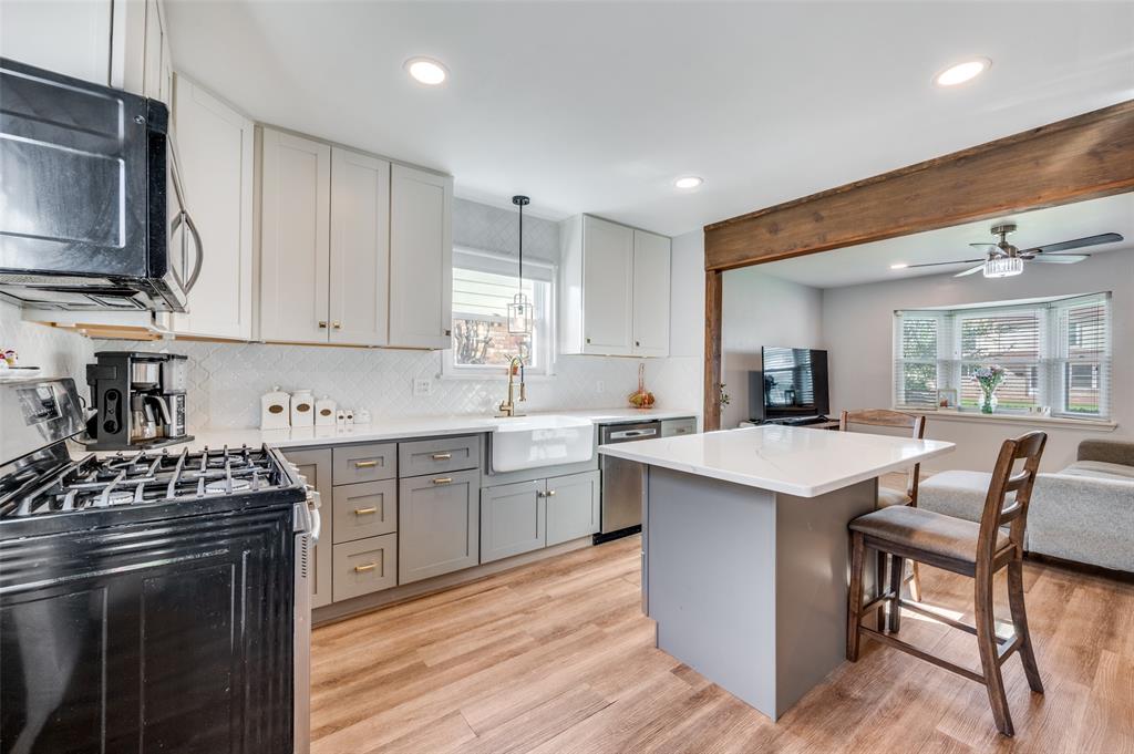 2924 West 11th Street Irving, TX 75060 - Photo 37 of 39 a kitchen with a sink stove and microwave