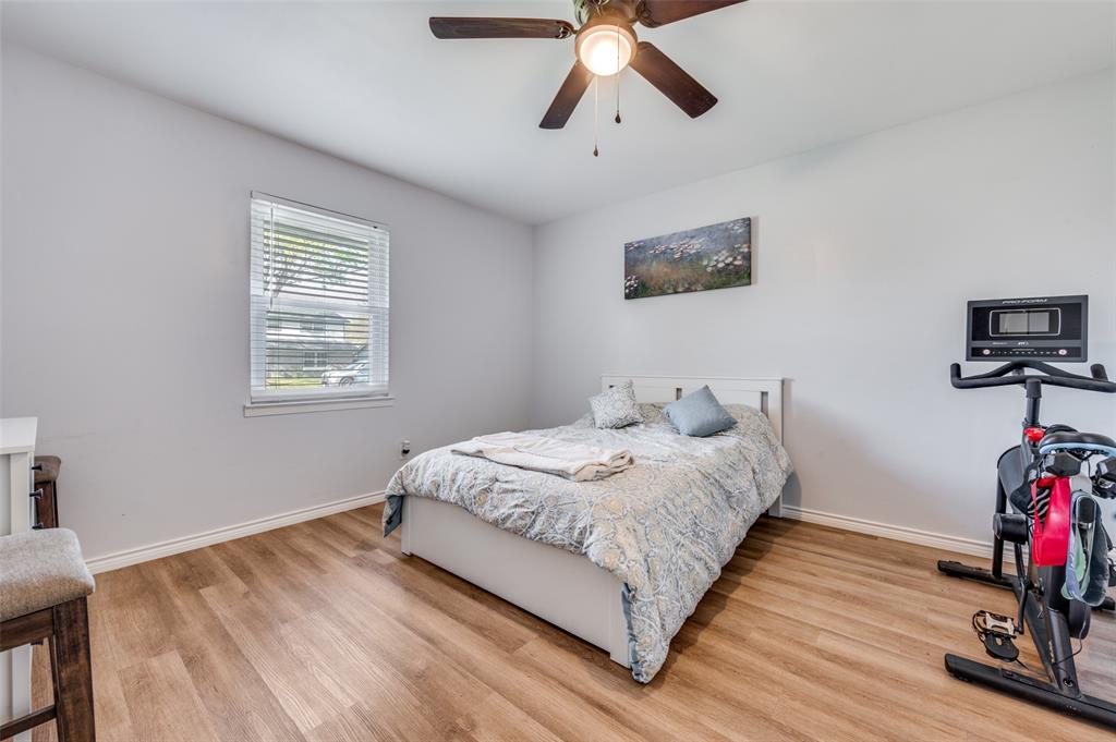 2924 West 11th Street Irving, TX 75060 - Photo 12 of 39 a bedroom with a bed and wooden floor