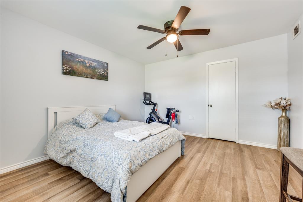 2924 West 11th Street Irving, TX 75060 - Photo 15 of 39 a bedroom with a bed and a wooden floor