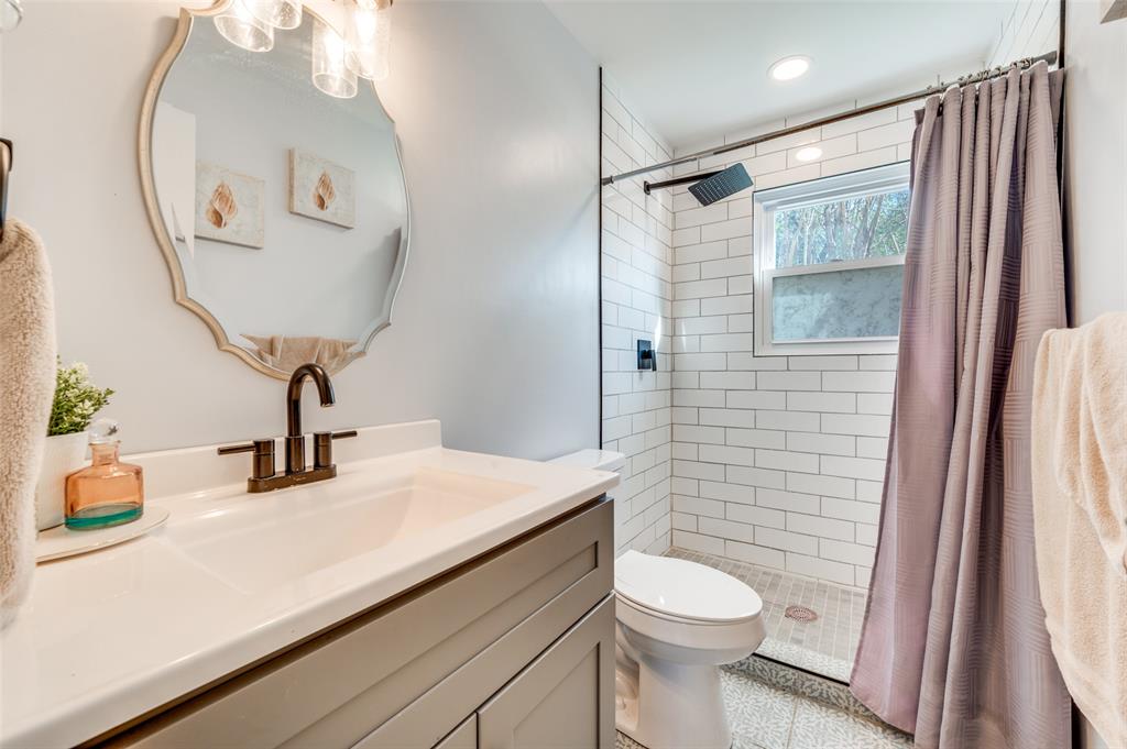 2924 West 11th Street Irving, TX 75060 - Photo 16 of 39 a bathroom with a sink a toilet and shower