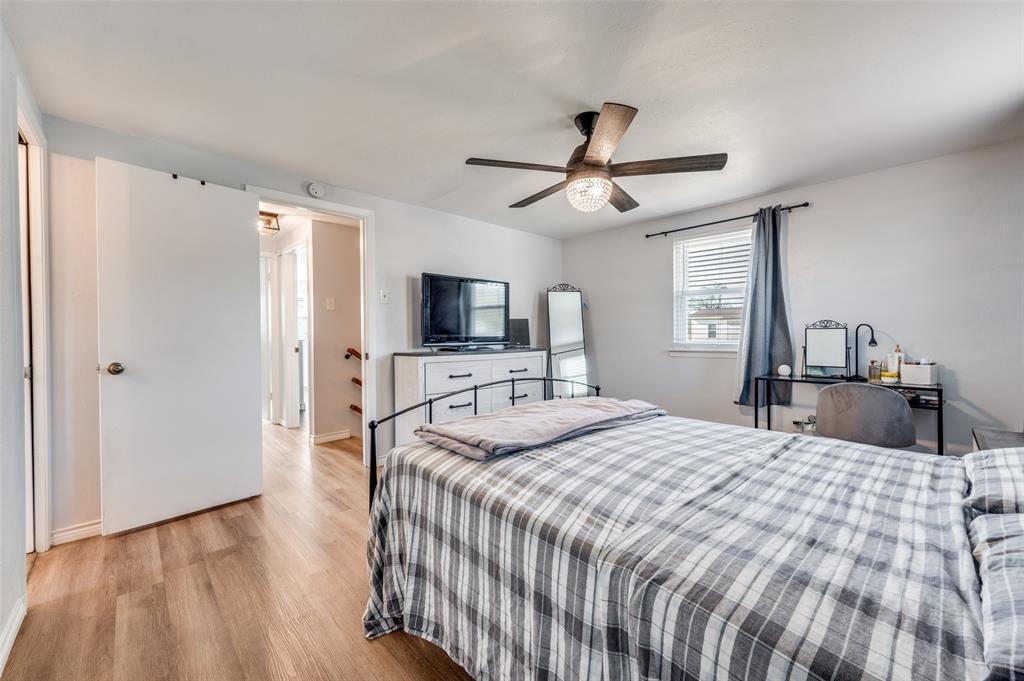 2924 West 11th Street Irving, TX 75060 - Photo 17 of 39 a bedroom with a bed and a flat screen tv