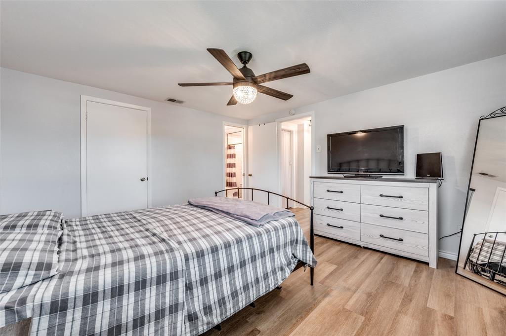 2924 West 11th Street Irving, TX 75060 - Photo 18 of 39 a bedroom with a bed and flat screen tv