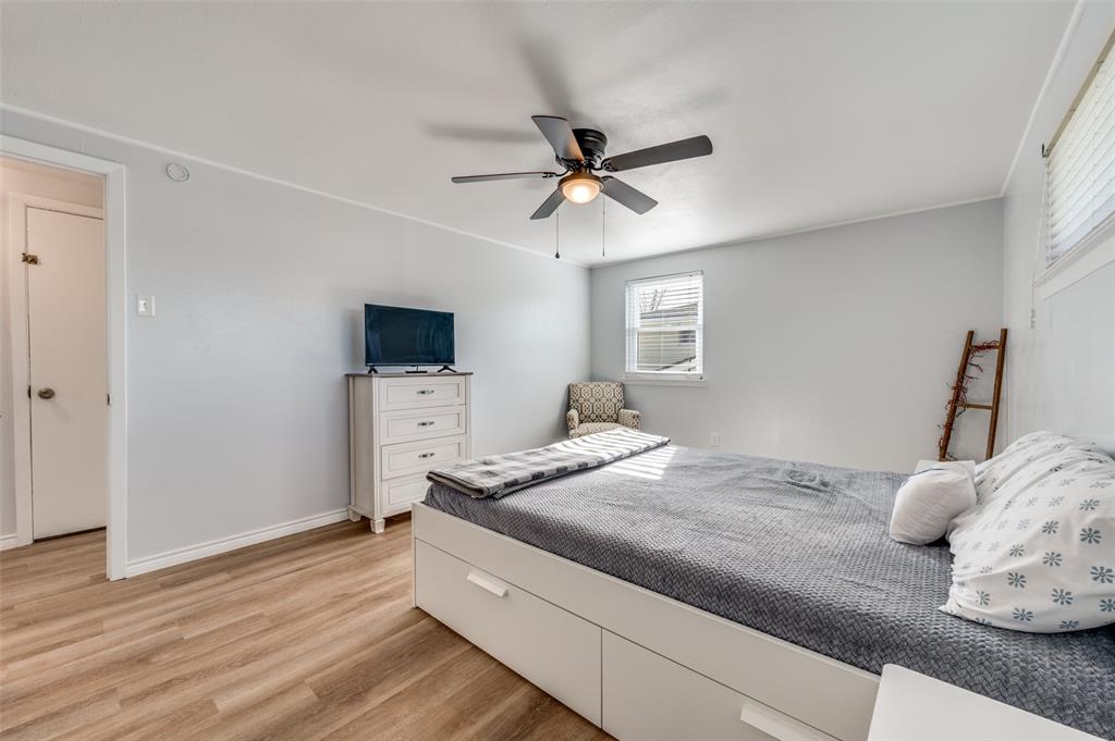 2924 West 11th Street Irving, TX 75060 - Photo 22 of 39 a bedroom with a bed and a flat screen tv