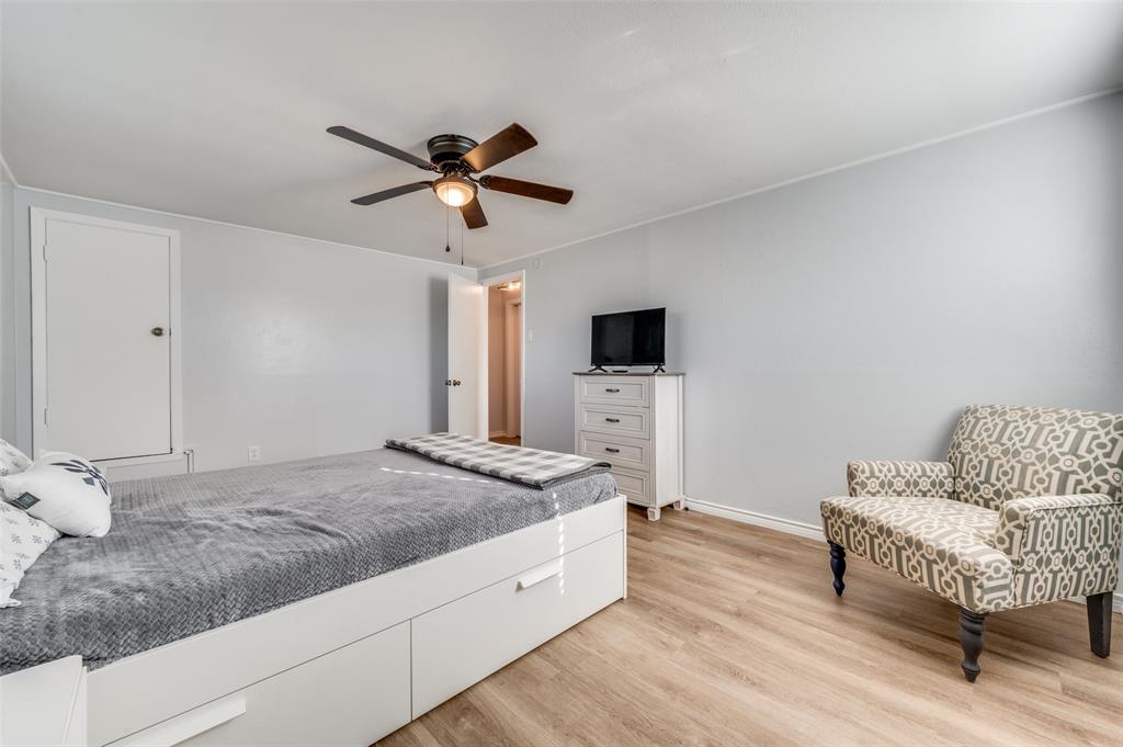 2924 West 11th Street Irving, TX 75060 - Photo 24 of 39 a spacious bedroom with a bed and a couch