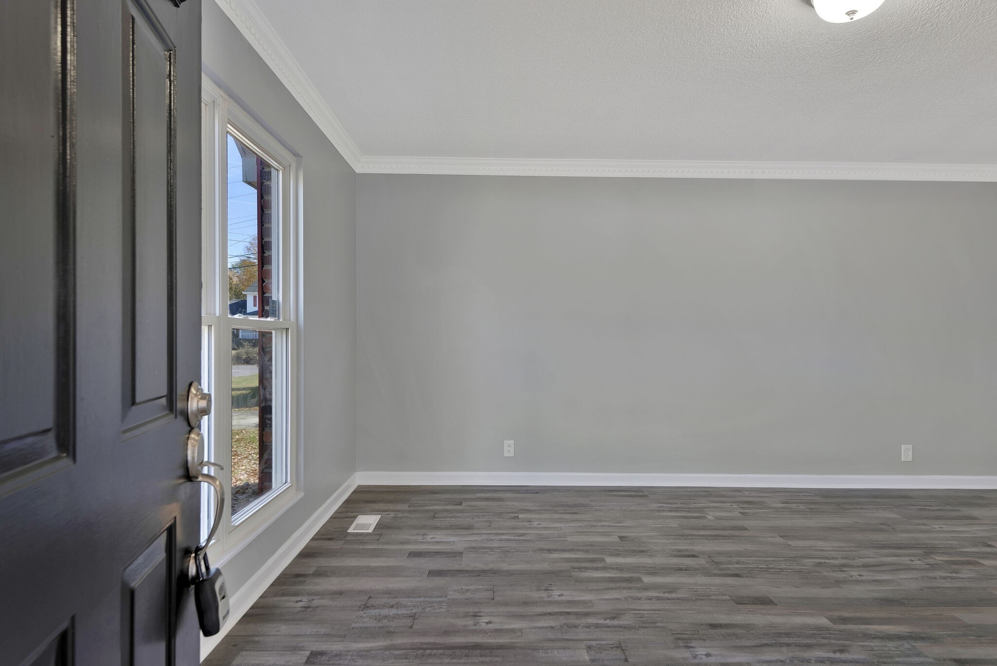 3005 Stone Bridge Road Antioch, TN 37013 - Photo 4 of 17 a view of an empty room with wooden floor and a window
