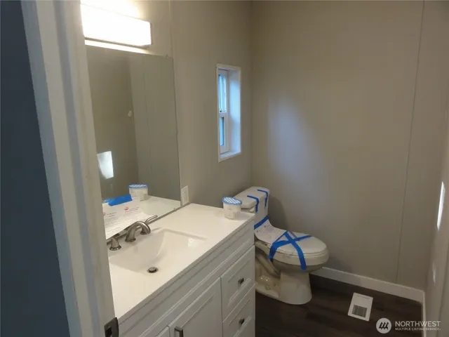 a bathroom with a sink toilet and vanity