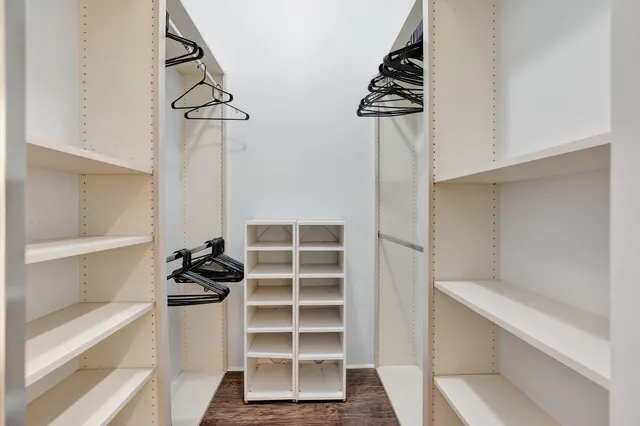 a view of walk in closet with empty racks