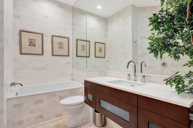 a bathroom with a sink toilet a mirror and shower