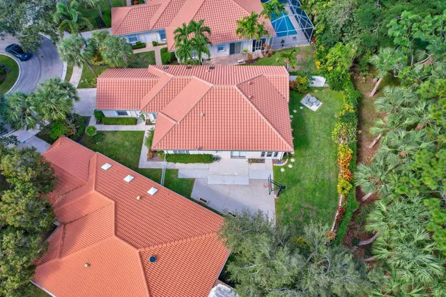 an aerial view of a house with garden space and a street view