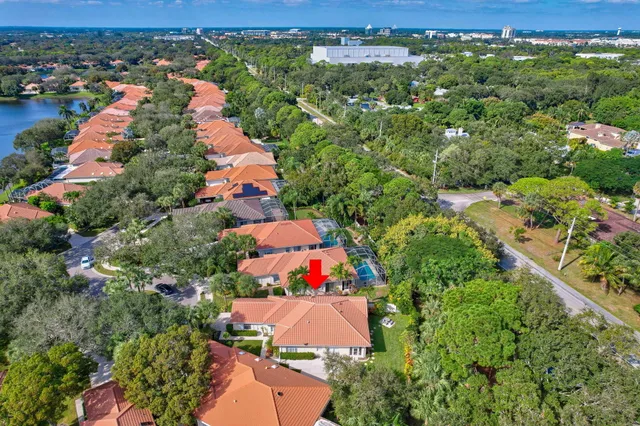an aerial view of residential houses with outdoor space and trees