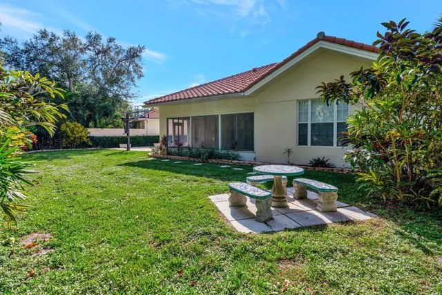 a view of a house with pool and a yard
