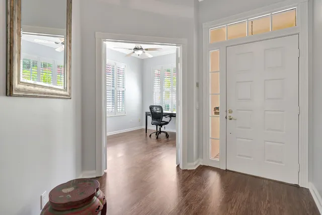 a view of a livingroom with wooden floor and a window