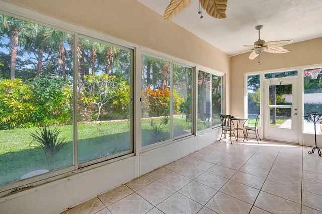 a view of an entryway with floor to ceiling windows and outside view