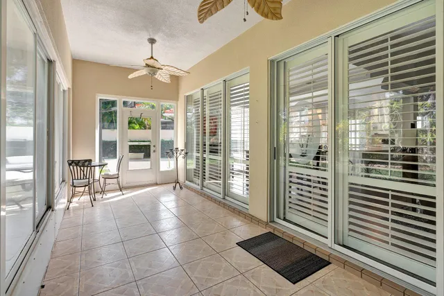 a view of a livingroom with a floor to ceiling window and stairs