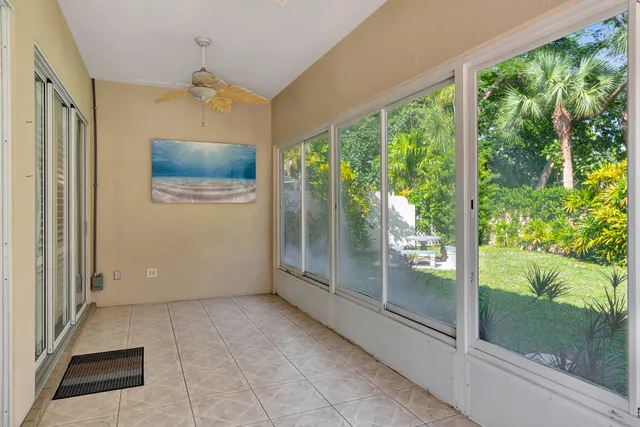 a view of a hallway with wooden floor and windows