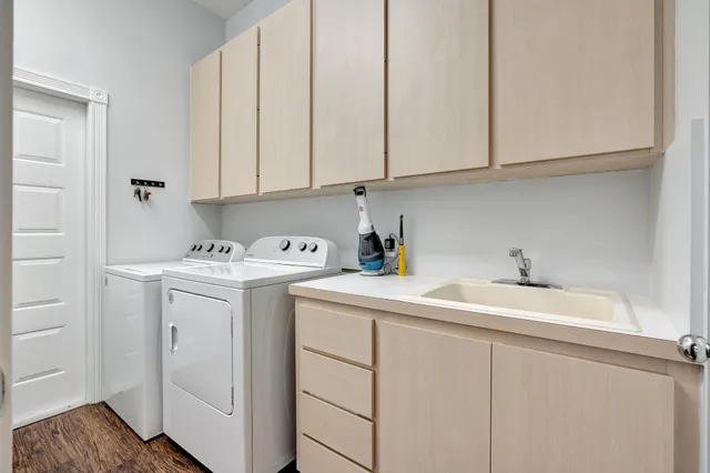 a utility room with sink dryer and washer