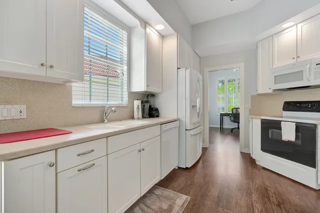 a kitchen with sink cabinets and window