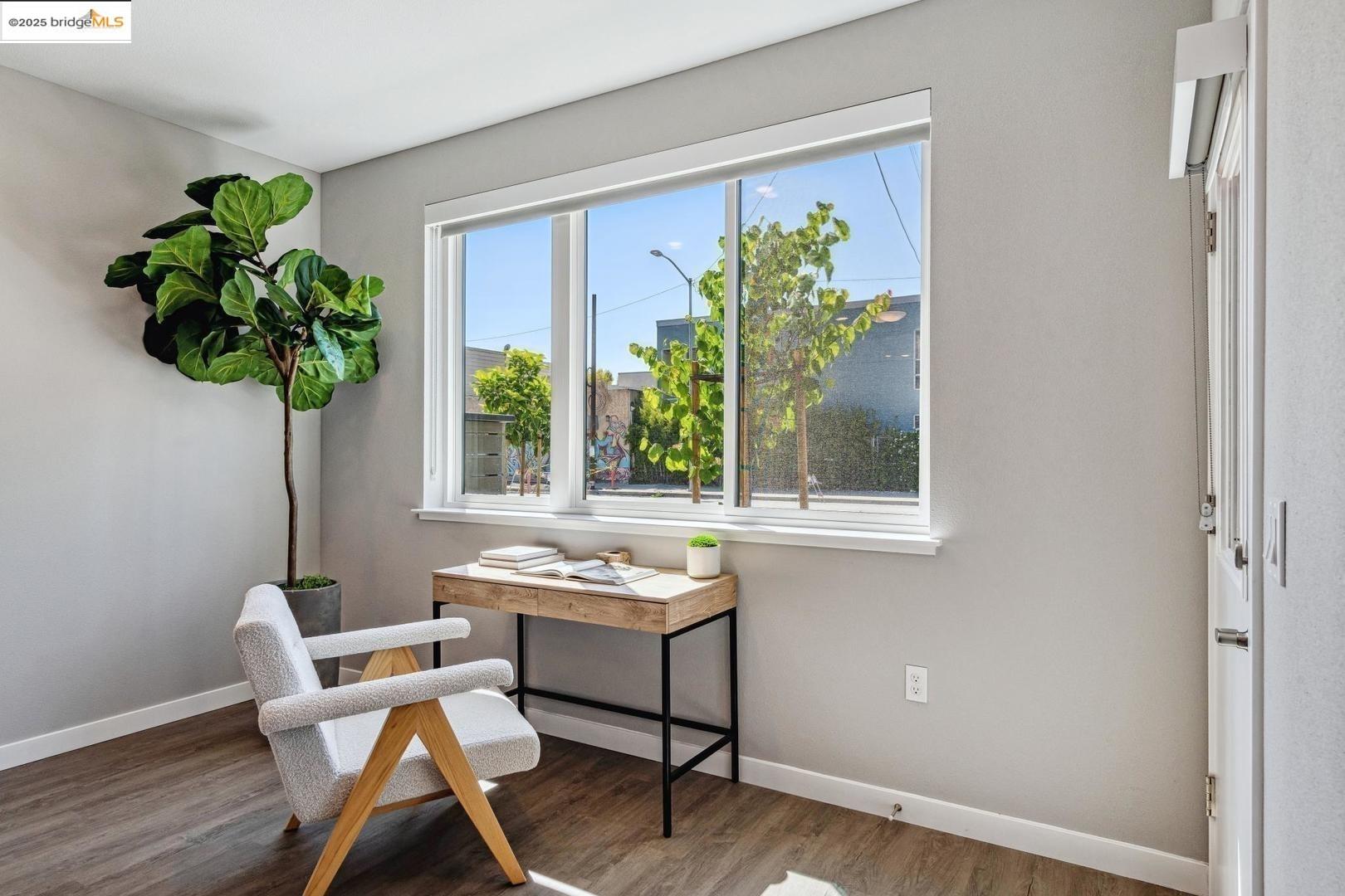 2400 Adeline Street, Unit 101 Oakland, CA 94607 - Photo 4 of 17 a dining room with furniture potted plants and wooden floor
