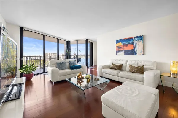 a living room with furniture and a large window